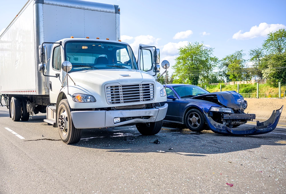 Collision of a semi truck with box trailer a passenger car on the highway road, as a result of which both cars were damaged, await the arrival of the police to draw up an accident report